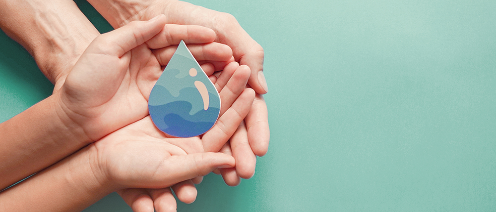 Adult and child hands holding paper cut water drop, World Water